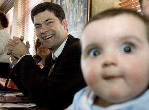 Action Democratique leader Mario Dumont (L)  laughs during a luncheon in Delson, Quebec, March 15, 2007. Quebec voters will go to the polls in a provincial election on March 26. REUTERS/Christinne Muschi    (CANADA) - GM1DUVAVWFAA